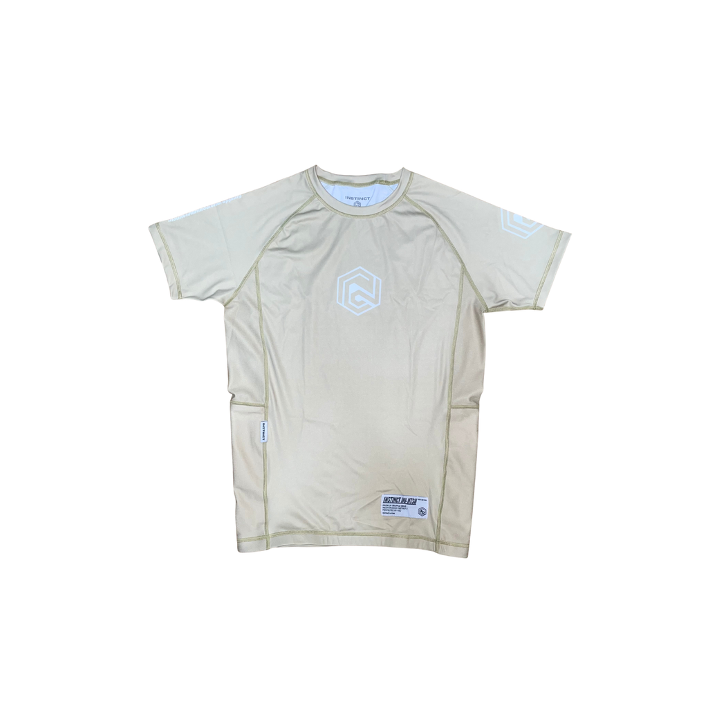 Beige CORE V2 short sleeve rash guard by INSTINCT JIU-JITSU, shown on a model, made for martial arts and training.