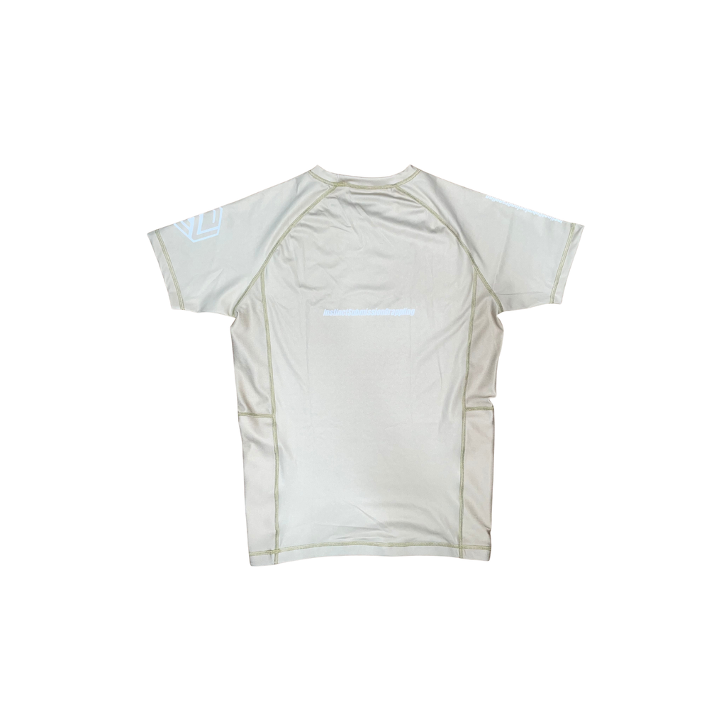 Beige Instinct Jiu-Jitsu CORE V2 short sleeve rash guard with black logo, fitted athletic design for martial arts training.