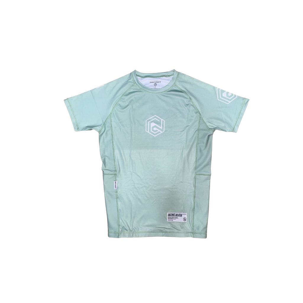 Instinct Jiu-Jitsu CORE V2 short sleeve rash guard in sage green with logo design, made of stretchy, quick-drying fabric for martial arts.