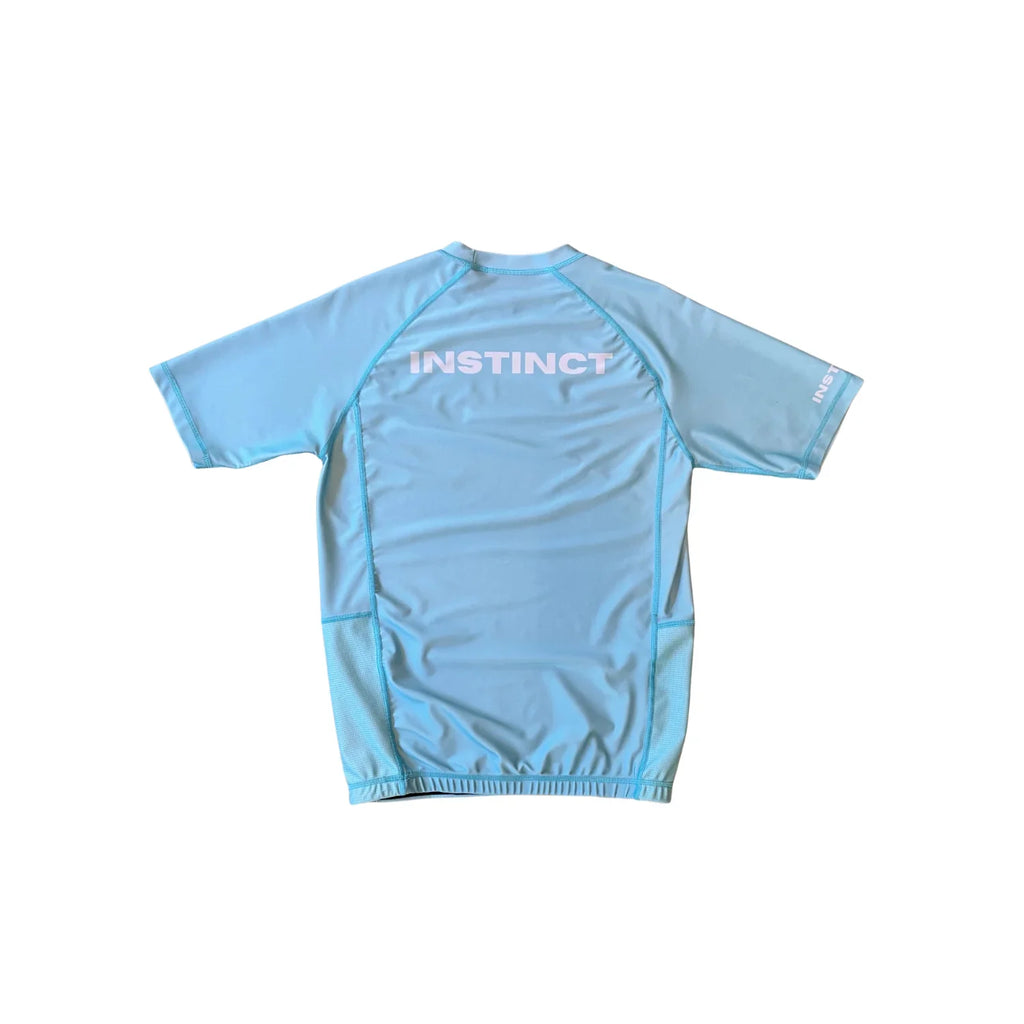 Instinct Jiu-Jitsu CORE Series short sleeve rash guard in blue with logo and sleek design, designed for combat sports and training.