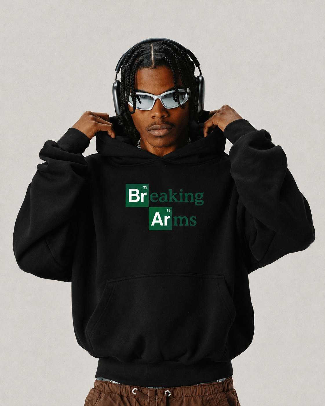 Black Breaking Arms hoodie from BJJ World, green tile chest print worn hood up.