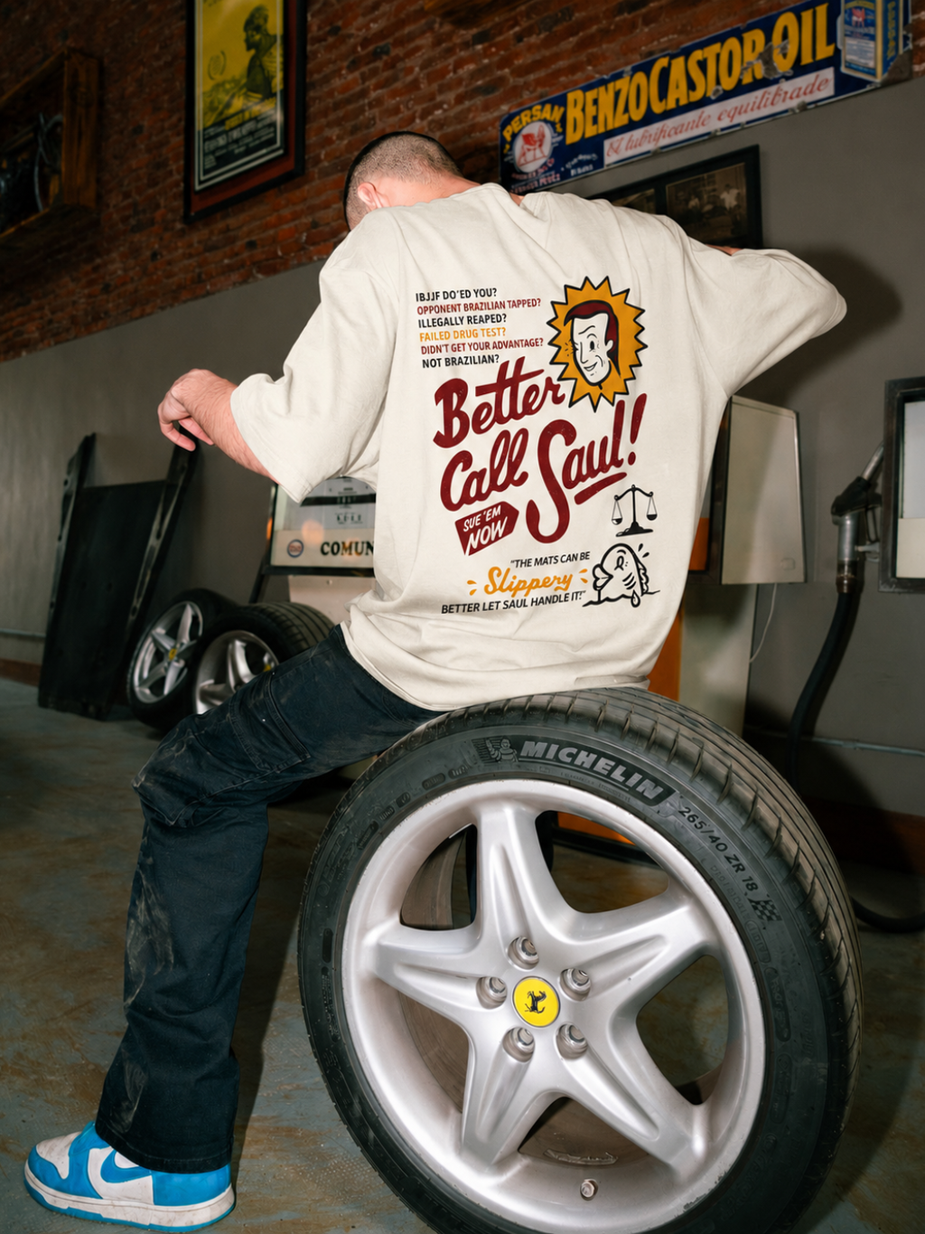 Cream Better Call Saul tee from BJJ World, back print worn in a garage.