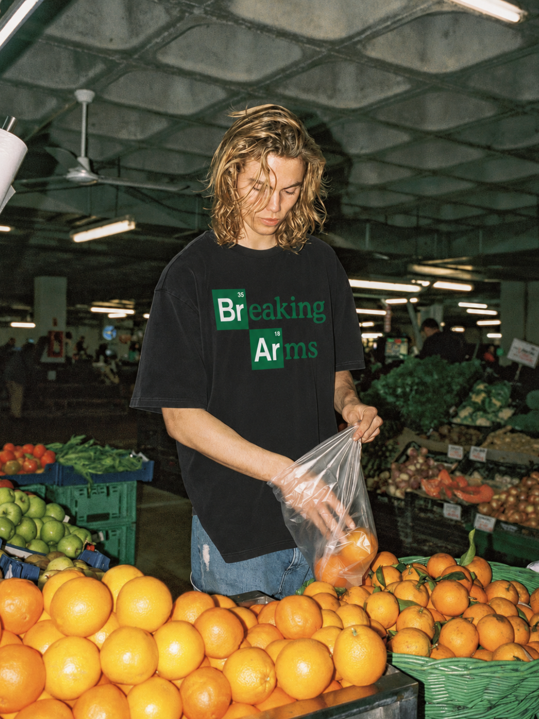 Black Breaking Arms tee from BJJ World, worn in a grocery produce aisle.