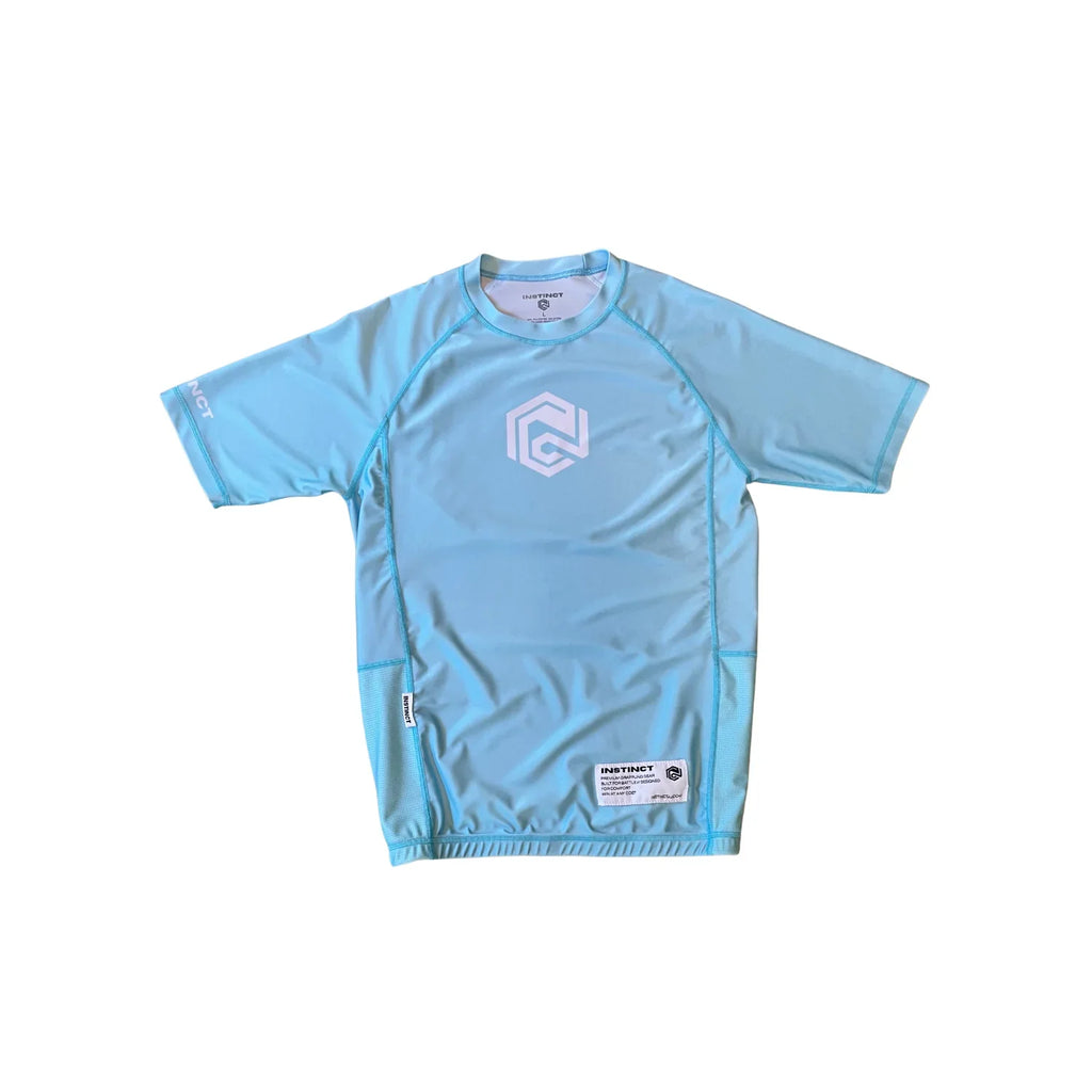 Instinct Jiu-Jitsu CORE Series short sleeve rash guard in blue with logo, designed for grappling and training.