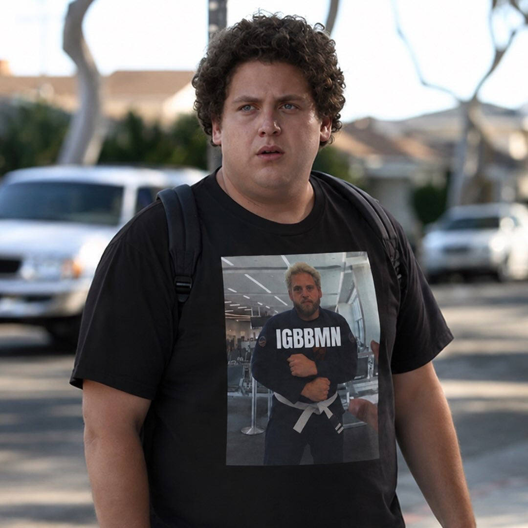 Black IGBBMN tee from BJJ World, front photo print worn on a suburban street.